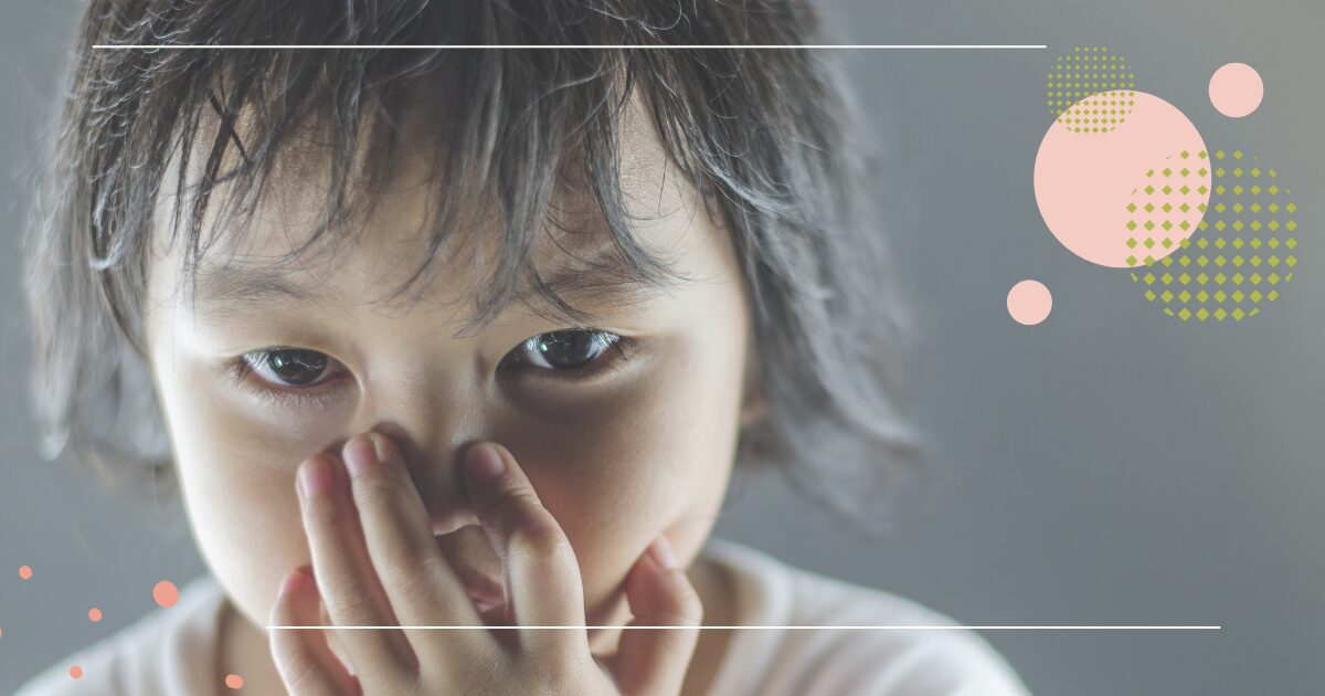 Close-up of a child covering their mouth, with graphic design elements overlaid.