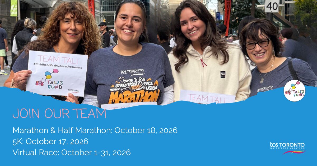 Four women smiling at a marathon event holding Team Tali signs, with event dates listed below